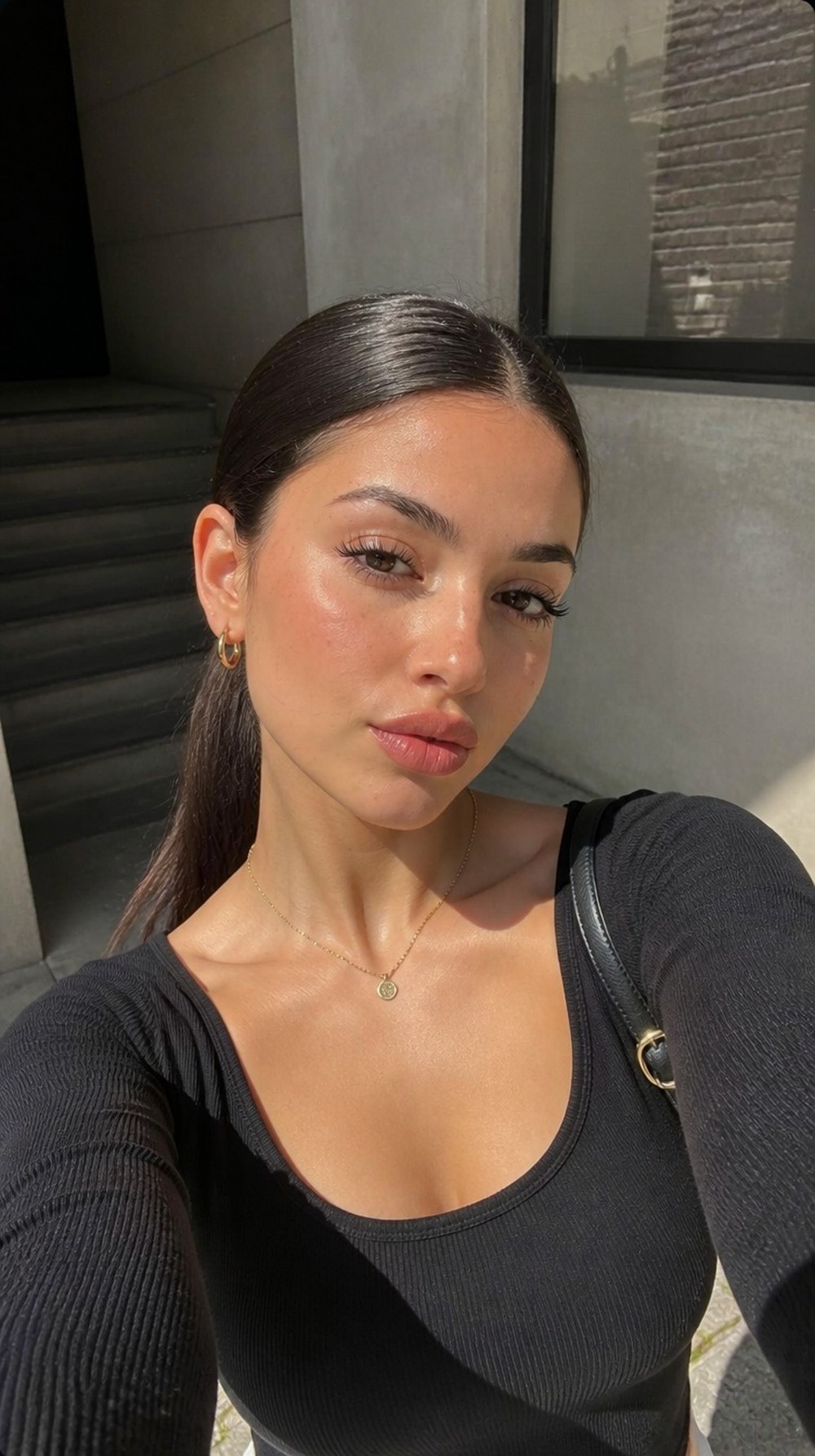 A woman with sleek, styled hair